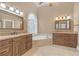 Luxurious bathroom featuring double vanities, a jetted tub, and modern fixtures at 240 River Cove Mdws, Social Circle, GA 30025