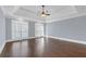 Bright bedroom with tray ceiling, hardwood floors, and large windows at 240 River Cove Mdws, Social Circle, GA 30025