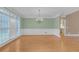 Elegant dining room featuring large windows, hardwood floors, and a stylish chandelier at 240 River Cove Mdws, Social Circle, GA 30025