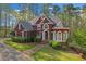 Beautiful brick home showcasing lush landscaping, a well-kept lawn, and elegant architectural details at 240 River Cove Mdws, Social Circle, GA 30025