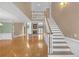 Bright foyer with hardwood floors, staircase and view to the formal living space at 240 River Cove Mdws, Social Circle, GA 30025