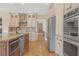 Modern kitchen with stainless steel appliances, granite countertops, and ample cabinet space at 240 River Cove Mdws, Social Circle, GA 30025