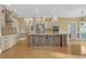Spacious kitchen with an island, custom cabinets, hardwood floors, and modern appliances at 240 River Cove Mdws, Social Circle, GA 30025