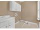 Functional laundry room with a sink, cabinets, and space for a washer and dryer at 240 River Cove Mdws, Social Circle, GA 30025