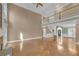 Large living room featuring a fireplace, tall ceilings, wood floors, and great natural light at 240 River Cove Mdws, Social Circle, GA 30025