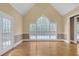Spacious living room with hardwood floors, large windows, and a deck at 240 River Cove Mdws, Social Circle, GA 30025