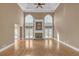 Spacious living room with fireplace, hardwood floors, soaring ceilings, and french doors to the backyard at 240 River Cove Mdws, Social Circle, GA 30025