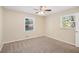 Sunny bedroom with carpet, fresh paint, a ceiling fan, and natural lighting at 293 Howell Sw Dr, Atlanta, GA 30331