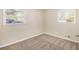 Comfortable bedroom with neutral carpet, fresh paint, and ample sunlight from two windows at 293 Howell Sw Dr, Atlanta, GA 30331