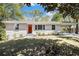 Charming single-story home with a white brick exterior and a vibrant red front door at 293 Howell Sw Dr, Atlanta, GA 30331