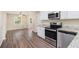 Modern kitchen featuring stainless steel appliances, granite countertops, and white cabinets at 293 Howell Sw Dr, Atlanta, GA 30331