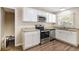 Well-lit kitchen with white cabinets, granite countertops, and stainless steel appliances at 293 Howell Sw Dr, Atlanta, GA 30331