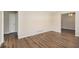 Spacious room with hardwood floors, a door, and an open entrance at 293 Howell Sw Dr, Atlanta, GA 30331