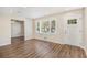 Bright living room with hardwood floors, fresh paint, and large windows providing natural light at 293 Howell Sw Dr, Atlanta, GA 30331