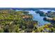 Aerial view of waterfront homes nestled among lush greenery and the serene lake at 3578 Hope Rd, Cumming, GA 30041