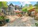 Large backyard features a stone patio, outdoor dining area, and a covered porch at 3578 Hope Rd, Cumming, GA 30041