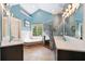 Bright bathroom with double vanities, soaking tub under window, and glass-enclosed shower at 3578 Hope Rd, Cumming, GA 30041