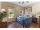 Cozy bedroom with hardwood floors, comfy bed, and windows allowing natural light at 3578 Hope Rd, Cumming, GA 30041