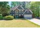 Charming two-story home featuring a stone accent wall, two-car garage, and a lush, green lawn at 3578 Hope Rd, Cumming, GA 30041