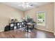Well-lit home office features a desk, chair, storage unit, and wood floors at 3578 Hope Rd, Cumming, GA 30041