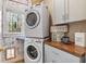 Charming laundry area boasts stacked washer and dryer units and stylish decor at 3578 Hope Rd, Cumming, GA 30041