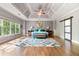 Spacious main bedroom with trey ceiling, wooden floors, area rug, and large windows at 3578 Hope Rd, Cumming, GA 30041