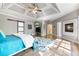 Spacious main bedroom featuring a tray ceiling, fireplace, barn door and large windows at 3578 Hope Rd, Cumming, GA 30041