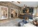 Cozy sun room featuring a wet bar, comfortable seating, and a view of the lush backyard at 3578 Hope Rd, Cumming, GA 30041