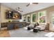 Cozy sun room featuring a wet bar, comfortable seating, and a view of the lush backyard at 3578 Hope Rd, Cumming, GA 30041