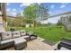 Outdoor deck featuring comfortable seating, pergola, and a spacious grassy backyard at 140 Apple Valley Dr, Woodstock, GA 30188