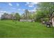 Expansive backyard offers plenty of green space, mature trees, and a shed for storage at 140 Apple Valley Dr, Woodstock, GA 30188