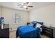 Comfortable bedroom features a ceiling fan, neutral walls and a window providing natural light at 140 Apple Valley Dr, Woodstock, GA 30188