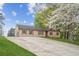 This single-story house features a large driveway and a well-maintained front yard at 140 Apple Valley Dr, Woodstock, GA 30188