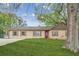 Charming single-story home featuring a well-maintained lawn and a welcoming red front door at 140 Apple Valley Dr, Woodstock, GA 30188