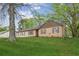 A quaint single-story home with a manicured green lawn and mature trees in a quiet setting at 140 Apple Valley Dr, Woodstock, GA 30188