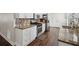 Modern kitchen with granite countertops, stainless steel appliances, and mosaic backsplash at 140 Apple Valley Dr, Woodstock, GA 30188