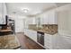 Bright kitchen featuring granite counters, stainless steel appliances, and ample cabinet space at 140 Apple Valley Dr, Woodstock, GA 30188