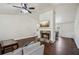 Bright living room features a stone fireplace, mounted TV, and wood floors at 140 Apple Valley Dr, Woodstock, GA 30188