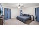 Spacious primary bedroom with a king-size bed, soft carpet, and plenty of natural light at 140 Apple Valley Dr, Woodstock, GA 30188