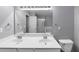 Bathroom with a double sink vanity, large mirror, and commode at 2180 Mill Garden Run, Buford, GA 30519