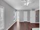 Spacious bedroom with hardwood floors, ceiling fan, and lots of natural light from two windows at 2180 Mill Garden Run, Buford, GA 30519