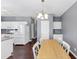 Open-plan dining area with hardwood floors located near the kitchen and stairs at 2180 Mill Garden Run, Buford, GA 30519