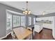 Dining area with hardwood floors has natural light and is situated beside the kitchen at 2180 Mill Garden Run, Buford, GA 30519