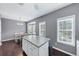 Bright, sunny kitchen features an island, hardwood floors, and lots of natural light at 2180 Mill Garden Run, Buford, GA 30519