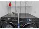 Laundry room with a washer and dryer and shelves above them for storage at 2180 Mill Garden Run, Buford, GA 30519