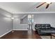 Open living room with hardwood floors, a ceiling fan, gray walls, and an accent lamp at 2180 Mill Garden Run, Buford, GA 30519