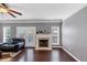 Cozy living room with hardwood flooring, a fireplace, french doors, and gray walls at 2180 Mill Garden Run, Buford, GA 30519