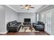 Living room features hardwood flooring, a ceiling fan, gray walls, and french doors at 2180 Mill Garden Run, Buford, GA 30519