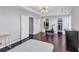 Well-lit main bedroom features tray ceilings, hardwood floors, a ceiling fan, and direct access to the closet at 2180 Mill Garden Run, Buford, GA 30519