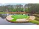 Stunning aerial perspective of a golf course island green surrounded by water, offering a unique challenge for golfers at 3022 Woodbridge Ln, Canton, GA 30114